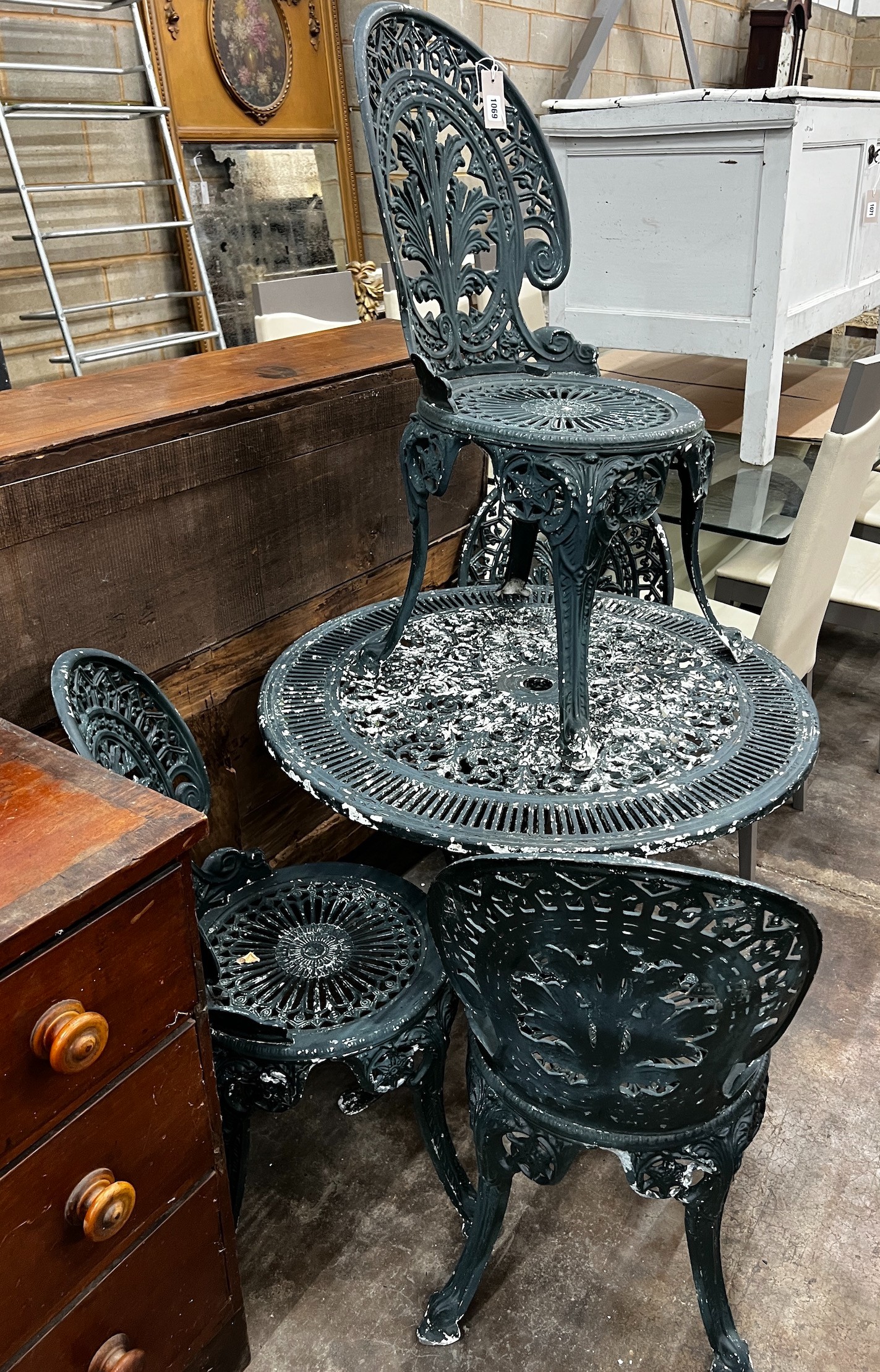 A Victorian style circular aluminium garden table and four chairs, table diameter 80cm height 69cm